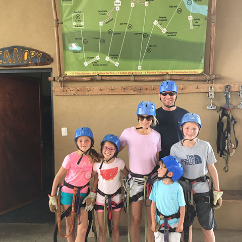 Family with young children ready for a family-friendly zipline canopy tour in Costa Rica