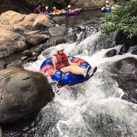 Traveler tubing through white water rapids on the Tenorio River in Costa Rica